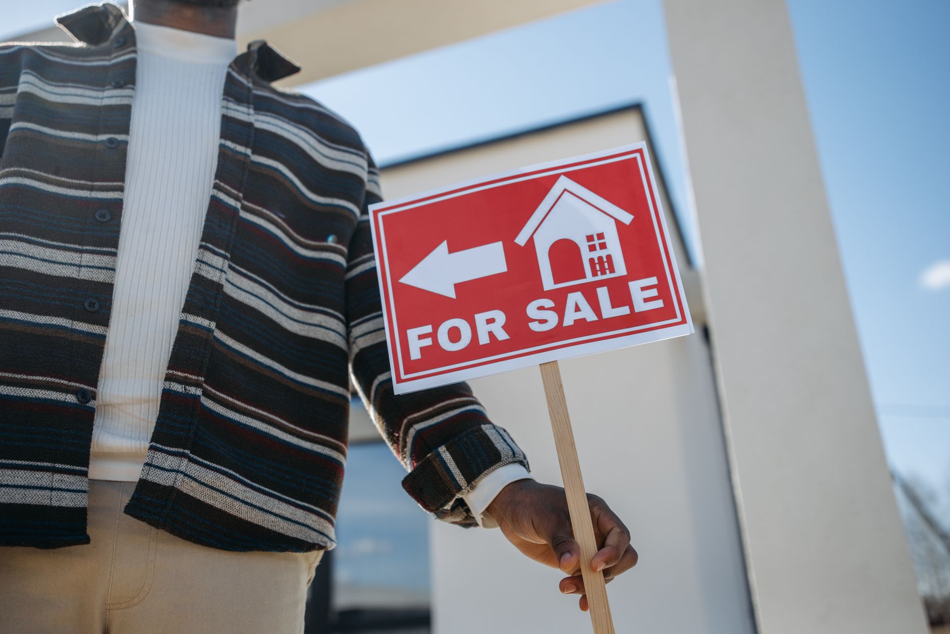 Happy couple receiving house keys while standing in front of a newly purchased home.